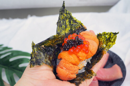 Fresh sea urchin (or uni), roe salmon and cavier over steamed rice and dried seaweed sheet. The best traditional food of Japan.