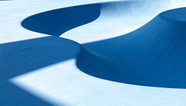 Showing empty blue skate bowl at skatepark, sunlight creating sharp shadows across curved coping