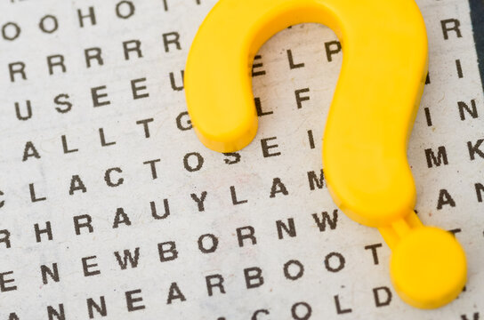 Yellow Question Mark Symbol on a Word Search Puzzle Background