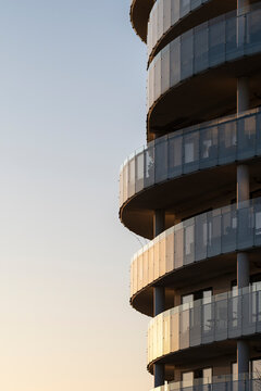 Vertical tower apartment building architecture with stacked balconies at twilight in Copenhagen Denmark