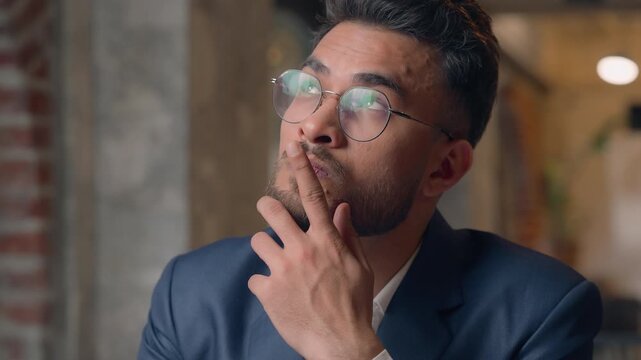 Close up thoughtful puzzled Hispanic businessman Arabian business man thinking Indian leader startup owner CEO think male guy pondering idea planning strategy unsure hesitate doubt question in office