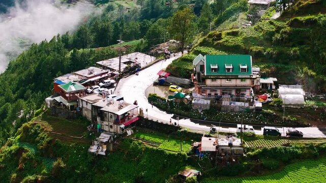 Scooter travels along curved mountain road, Halsema Highroad Point, Benguet