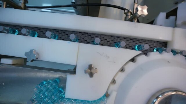 pharmaceutical industry - vaccine drug glass vial ampoules in a medicine factory creative view of small vials collected for manufacturing small glass injection moving in a pharma equipment machinery