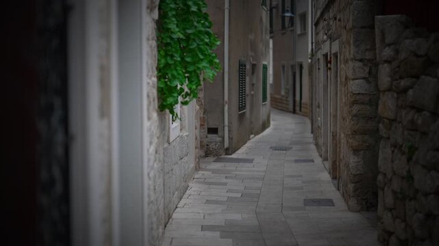 Narrow cobblestone street in a historic Mediterranean old town.