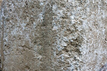 Obraz premium Close up texture of rough grey rock showing weathered cliff face for industrial design backgrounds and architectural concepts
