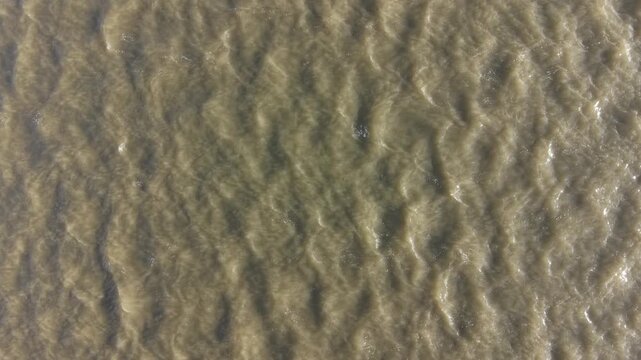 4K drone footage showing the River Mersey with calm estuary water and gentle ripples in soft daylight.