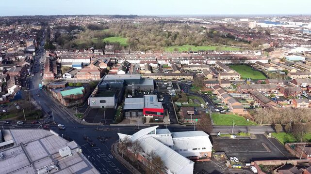 4K aerial video showing Birkenhead town centre Merseyside with urban streets and mixed rooftops in soft daylight.