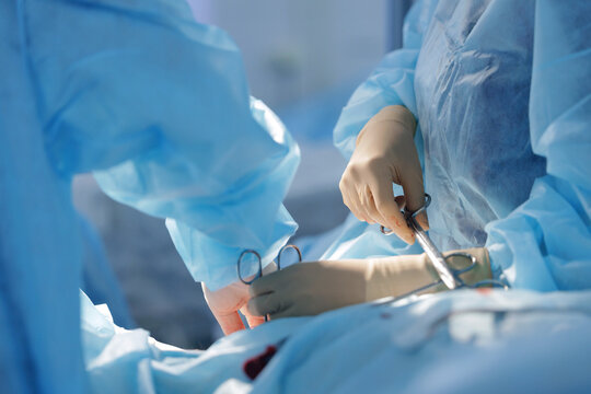 Surgeons performing abdominal surgery inside operating room