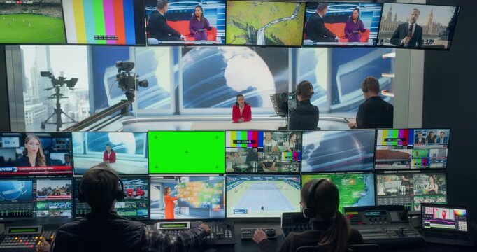 Backstage View of a Tv Station Production Control Room With Green Screen Mixed Mock-up Content Displays. Technicians Coordinate Switchers, Monitor Feeds, Cue Cameras, and Manage Live Newsroom Output.