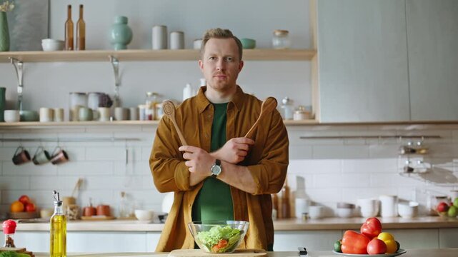 Chef holding wooden spatulas preparing tasty lunch standing home cuisine closeup