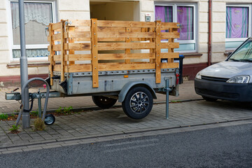 Naklejka premium Trailer with tall wooden side fence and latch closures parked roadside