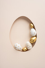 Minimal vertical soft beige composition featuring white and gold decorated eggs in an egg-shaped...