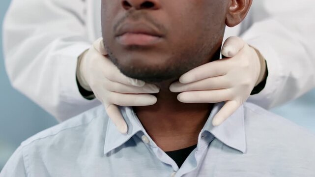 Doctor Carefully Palpates A Patient's Neck During Physical Exam, Checking