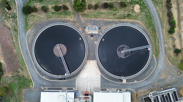 Aerial top down view of circular wastewater treatment tanks at industrial water facility