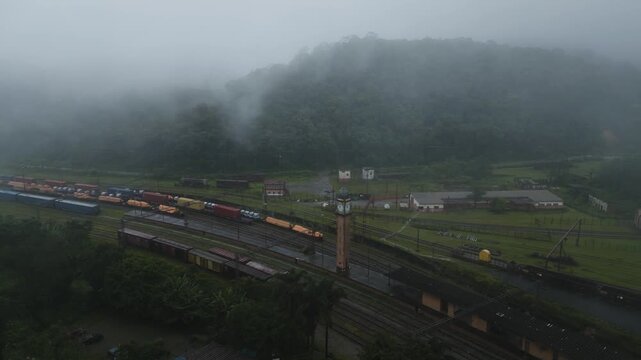 Drone footage of historic Paranapiacaba train station surrounded by fog and lush Atlantic rainforest in Santo Andre, Sao Paulo, Brazil.