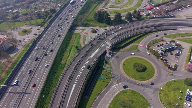 Aerial view of heavy traffic on A50 Tangenziale Ovest in Milan, Italy. Continuous vehicle flow highlights urban mobility, commuting patterns, and modern transport infrastructure.