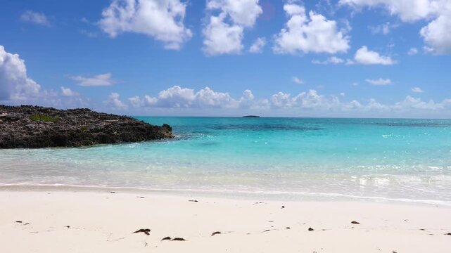 Stunning tropical beach landscape with white sand and crystal clear turquoise water under blue sky in exuma bahamas