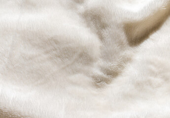 Soft white faux fur texture background with wavy organic folds for winter fashion and cozy home textile design © agrus