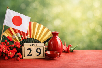 Showa Day celebration in Japan with flag, wooden calendar, origami crane and sake.