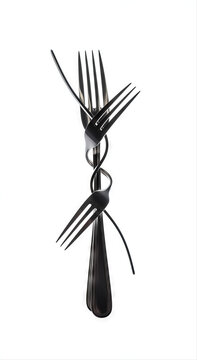 Artistic composition of a bent fork twisted intricately, isolated on a white background, showcasing unique metalwork design and elegant symmetry