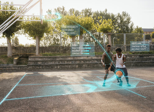 Two basketball players practicing dribbling on outdoor court with performance tracking overlay