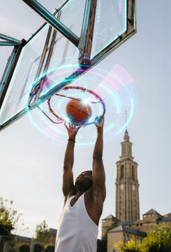 Basketball player performing dunk on outdoor court with augmented digital interface