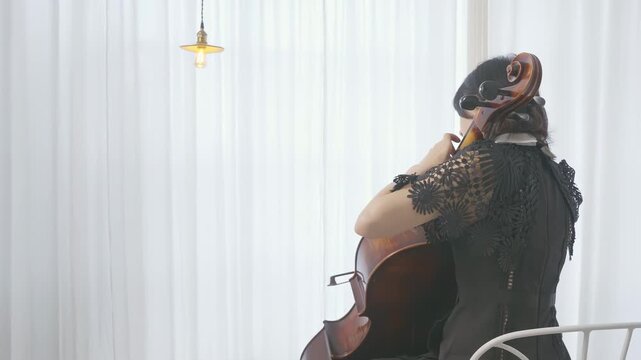 Elegant female musician cellist passionate performance on a cello, creating a symphony of sound, woman playing an instrument at a wedding, recital or rehearsal symphonic orchestra