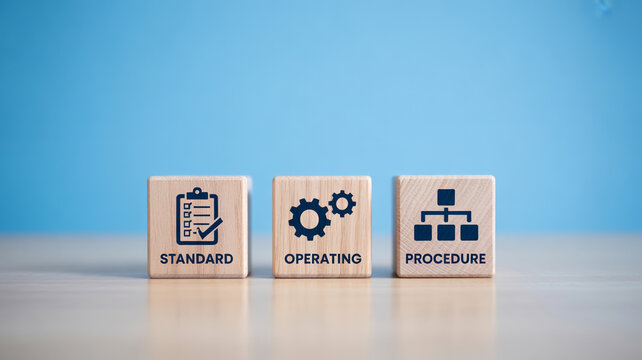 Three wooden blocks distinctly displaying Standard Operating Procedure with icons and text on a light surface against a vibrant blue background under 