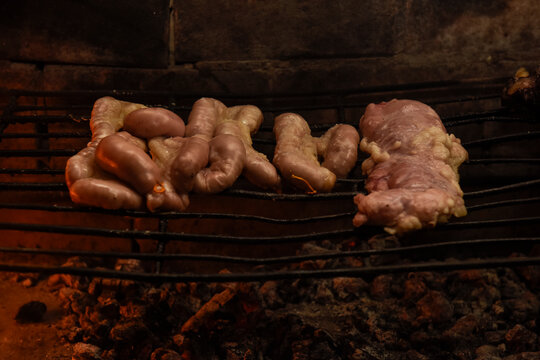 Cow bowels presented on a wooden board with ingredients, ready to grill