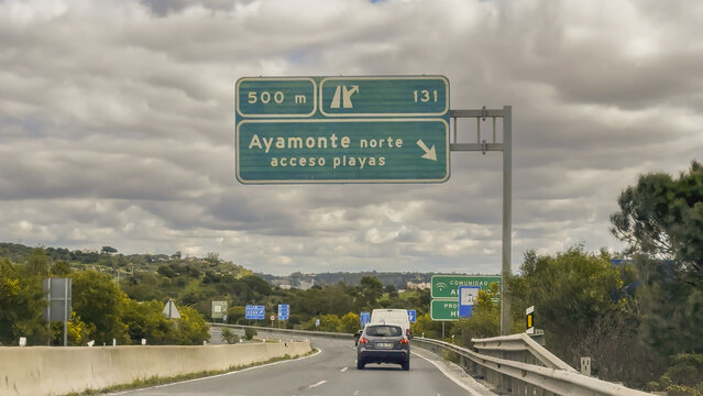 Large green sign welcomes drivers to Andalucia and the province of Huelva along the international motorway.