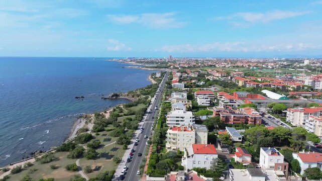 slow sideways aerial to sea looking all the way from southern Livorno up to the industrial northern ports, Livorno, Italy