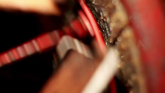 Close up view of the rotating metal gear inside an industrial machine