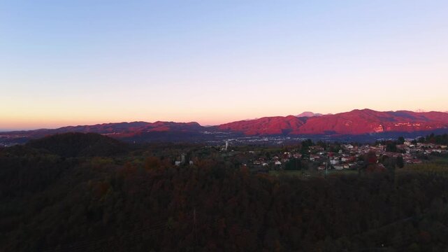 Aerial view of Pella village and mountains reflecting warm sunset light