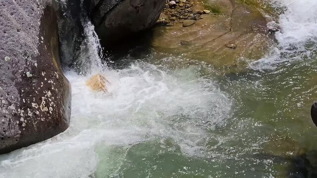 A block of wood turning vigorously in Travignolo creek.