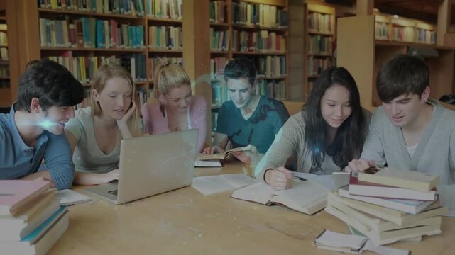 Blonde student leaning over laptop in library, enabling glowing study diagram emerging above table