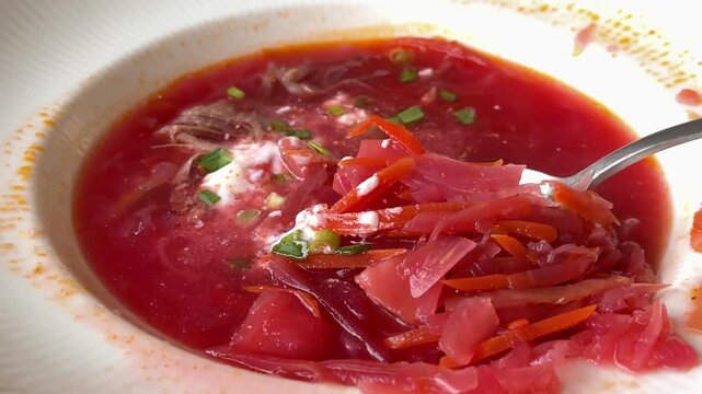 Ukrainian red soup borsch - appetizing soup with tomato paste, potato, spices cabbage and beetroot. Homemade dish. 4k footage.