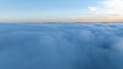 Panoramic aerial view above white clouds sun shining clear sky. Heavenly sunrise landscape high altitude drone flight. Meditation spirituality peace freedom inspiration concept nature scene.