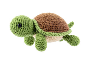 Fototapeta premium Handmade Crochet Turtle Plush Toy Isolated on Black Background for Kids and Nursery Decor