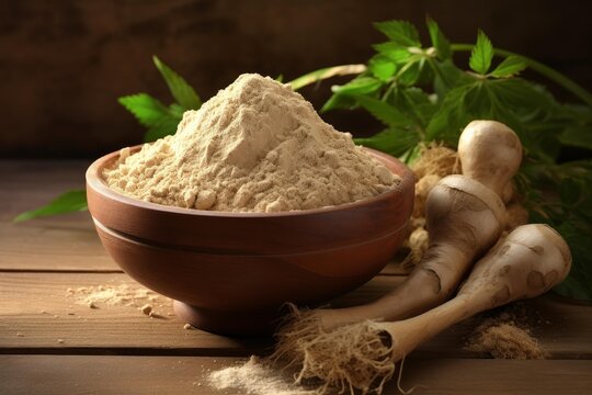 Maca root powder in a wooden bowl with fresh lepidium meyenii roots and green leaves