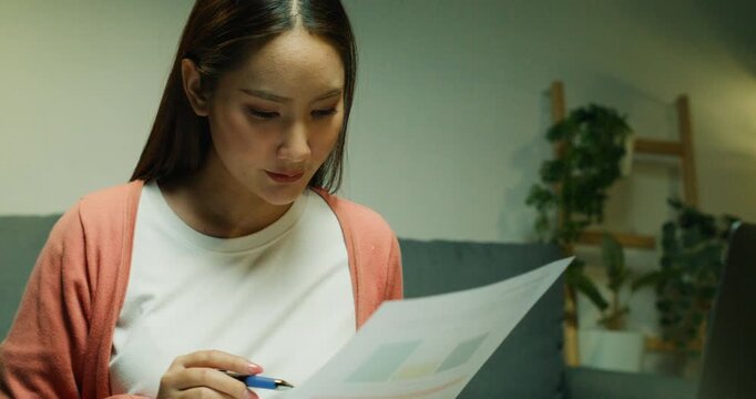 Dedicated female working at a desk on accounting tasks. She is calculating the tax balance and managing important financial data for a business report.