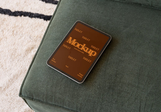 Real photo of Tablet on Green Couch. PSD Mockup.
