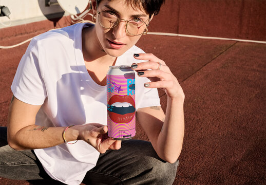 Real photo of woman Holding a Can on a Rooftop. PSD mockup.