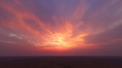 Fototapeta premium Sunset over vast plain with golden and crimson stratocumulus clouds. inspiring travel planning, travel magazines, designed for outdoor magazines and nature guides, used by clinicians.