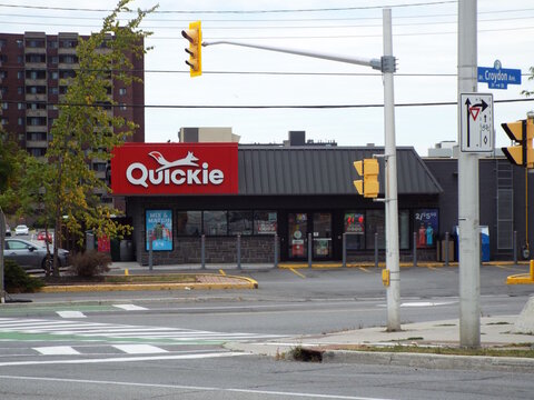 Ottawa, Ontario, Canada-July 22, 2025: The storefront of a "Quickie convenience store" captured from across an intersection at Croydon Avenue and Richmond.