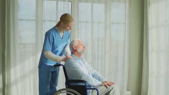 Help support retirement healthcare. Nurse helping old man in wheelchair. Patient and woman in nursing home for medical caregiver. Nurse taking care of paralyzed man in chair for people with disability