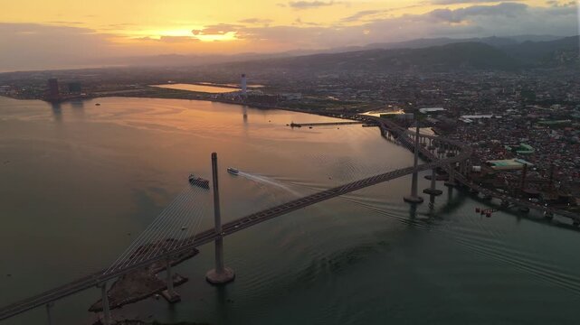 High-angle perspective of the bustling Cebu metropolis at dusk, showing the transition from daylight to glowing city lights