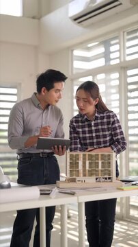 Asian Architects Collaborating Planning Project Reviewing Building Model Using Tablet Office Professional Design