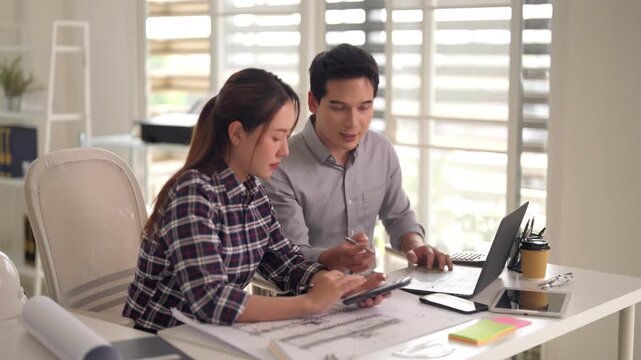 Asian adult architect engineer collaborate design project plan discuss work improve business growth modern office workspace startup environment creative solution development