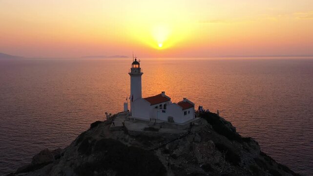The sun setting behind Knidos Lighthouse. Datca Peninsula in south-west corner of Turkey provides a natural boundary between Aegean Sea, Gulf of Gokova to the north. Dat&ccedil;a, Turkey