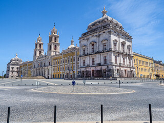 Obraz premium Famous Portuguese Royal Building, National Palace of Mafra or Palacio de Mafra. Monumental Baroque and Neoclassical Convent - Monastery, Basilica, with the tower carillons and Flemish bronze bells.